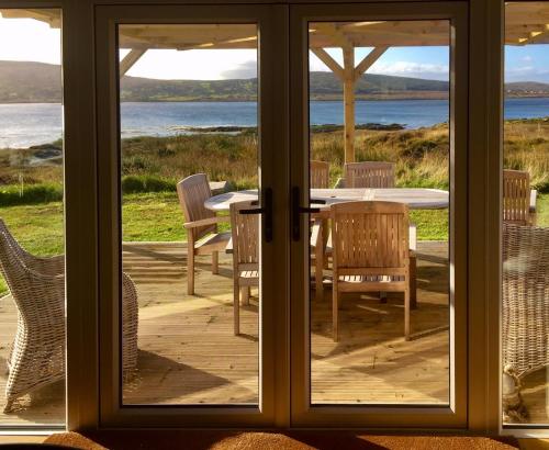 a view of a table and chairs through a window at The Oyster House in Dungloe