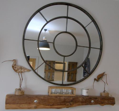 a large round mirror on a shelf in a room at The Oyster House in Dungloe