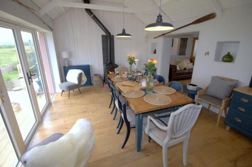 a dining room with a wooden table and chairs at The Oyster House in Dungloe