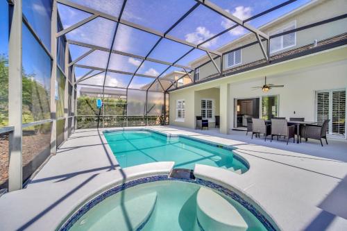 an indoor swimming pool in a house with a glass ceiling at Completely Remodeled 5 Bedroom Disney Pool Home in Davenport