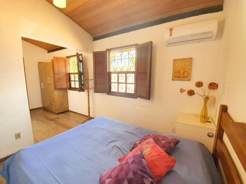 a bedroom with a blue bed and a window at Casa Guio in Salvador