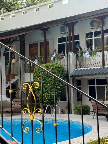 a house with a swimming pool in front of it at Parti Gras Hotel & Villas en Playa Potrero in Potrero