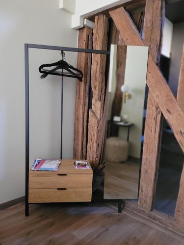 a mirror on top of a dresser in a room at Tresors de Sens in Sens