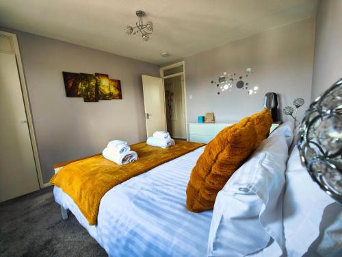 a bedroom with a large bed with towels on it at Haydon Hill House in Buckinghamshire