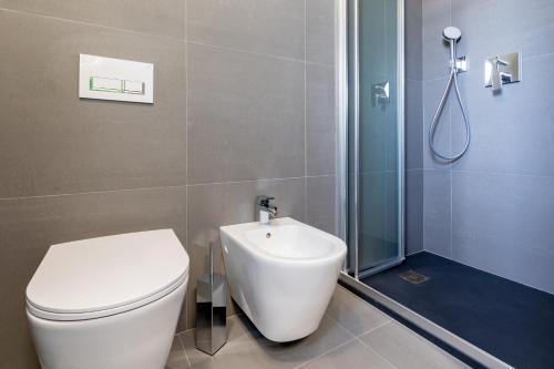 a bathroom with a toilet and a shower and a sink at Barighouse in Ulassai