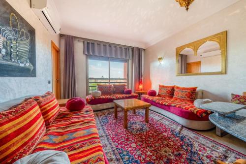 a living room with a couch and a table at 22 - Grand Palace Marrakesh in Marrakech