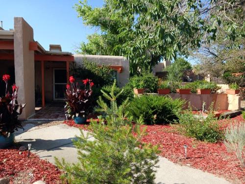 a garden with flowers and plants in front of a house at Randy's Roost in Santa Fe