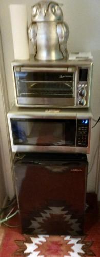 a toaster oven sitting on top of a microwave at Randy's Roost in Santa Fe
