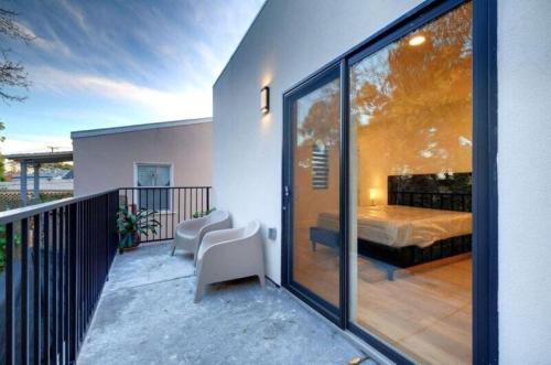 a balcony of a house with a bed and a bedroom at Dimond Abode Vacation Rental, Oakland California Dimond District in Oakland