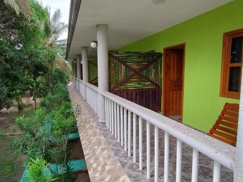 a front porch of a house with a green at Playa Encantada in Las Casitas