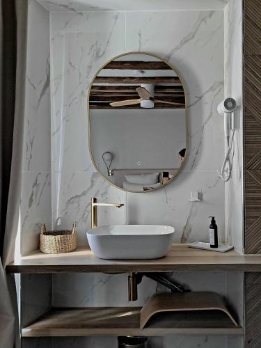 a bathroom with a sink and a mirror at Tresors de Sens in Sens