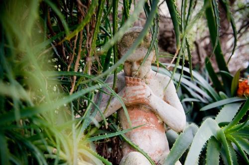 a statue of a person sitting in a tree at Yelki by the Sea in Encounter Bay