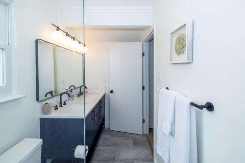 a bathroom with a sink and a mirror at Luxury 4BR Oasis with Pool, Hot Tub & Game Room! in Cedar Park