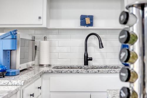 a kitchen counter with a sink and a faucet at Cozy Home with City Views in Columbus