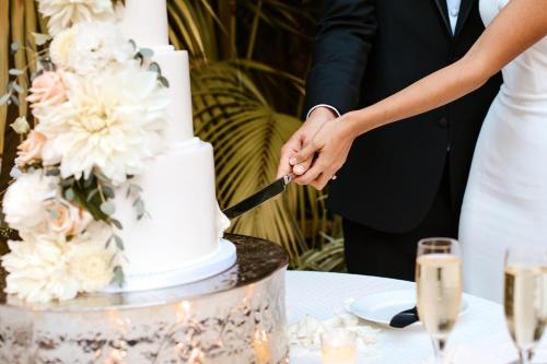 a bride and groom cutting their wedding cake at InterContinental Seattle Bellevue, by IHG in Bellevue