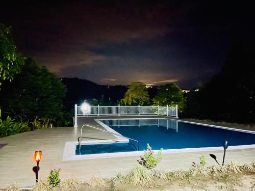 a swimming pool at night with the lights on at Casa campestre La Victoria-Private Village in Tocaima