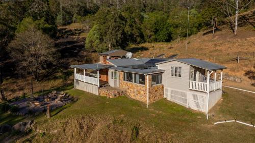 an aerial view of a house on a hill at Bellbird Rise Off-Grid Cottage in Conondale