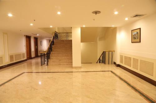 an empty hallway with a staircase in a house at The Ashok, New Delhi in New Delhi