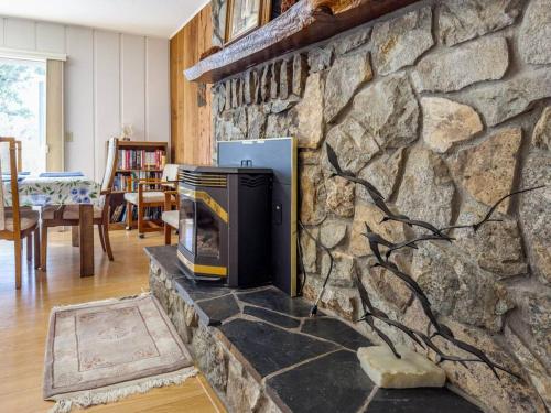 a stone wall with a fireplace in a living room at Yosemite Mountain Top Retreat Hilltop Manor Pool Spa in Mariposa