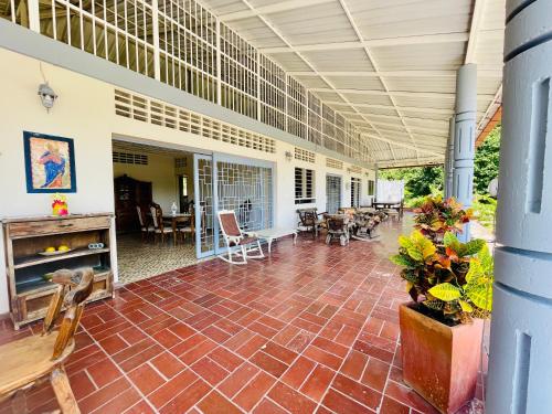 a large patio with chairs and tables at Casa campestre La Victoria-Private Village in Tocaima