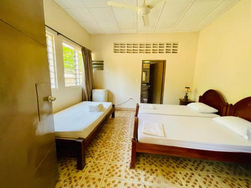 a bedroom with two beds and a window at Casa campestre La Victoria-Private Village in Tocaima