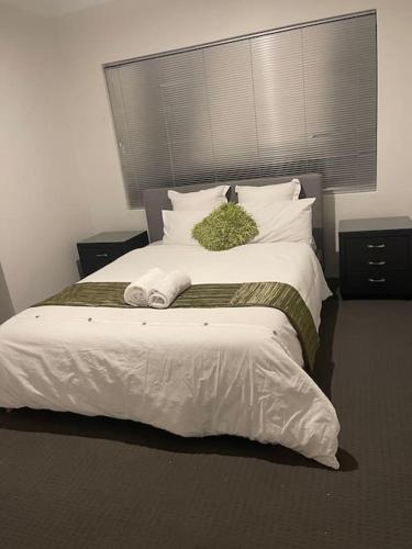 a bedroom with a large bed with white sheets and pillows at Elshaadai Homes in The Vines