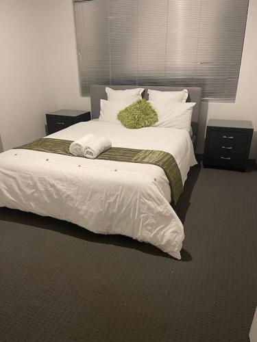 a bedroom with a large bed with white sheets and pillows at Elshaadai Homes in The Vines