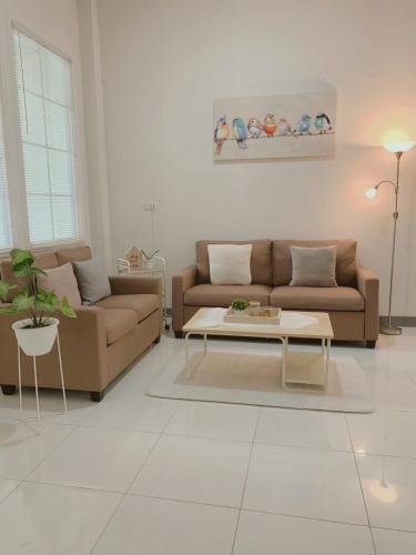 a living room with a couch and a coffee table at Rumahku Homestay in Makassar