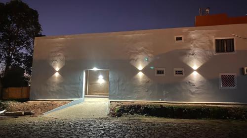 a white building with lights on the side of it at Apartamento RR Agradable y Moderno c 2 dormitorios y estacionamiento interno techado in Ciudad del Este