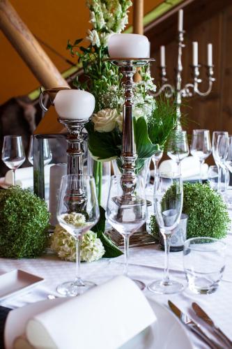 a table with wine glasses and flowers on it at Bjurfors Hotell & Konferens in Avesta
