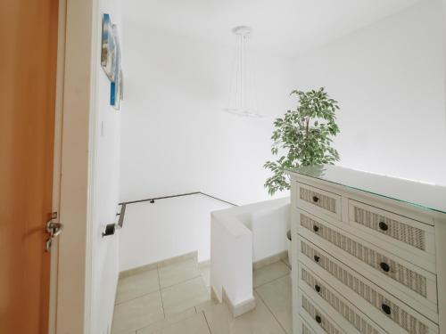 un bagno con vasca bianca e una pianta di Sunset Villa private complex heated pool a Ayia Napa