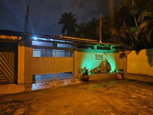 a house with green lights on the side of it at CIG Hostel in Goiânia