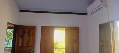 a room with two doors and a window at Casa da Lua-Taipu de fora-Ba in Taipu