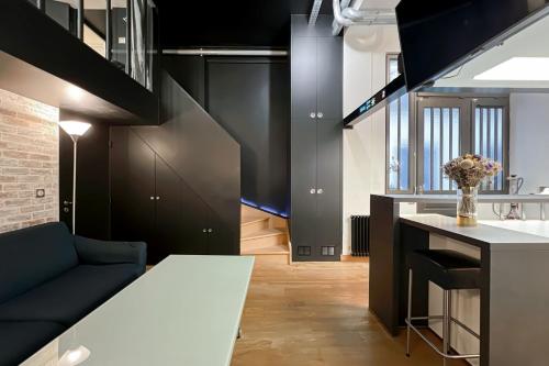 un salon avec des armoires noires et un canapé bleu dans l'établissement Charming atypical apartment - Gare de l'Est, à Paris