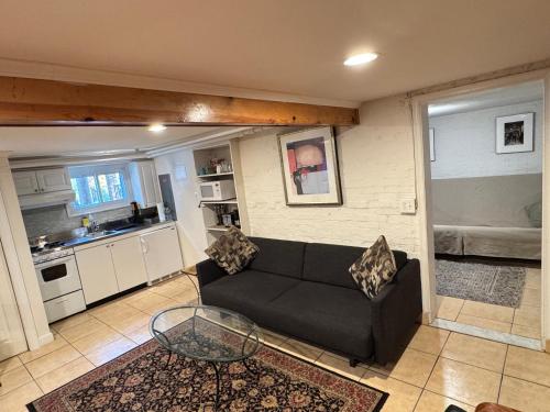 a living room with a couch and a glass table at First Floor One Bedroom Apartment with Full Kitchen & Bath in Washington, D.C.