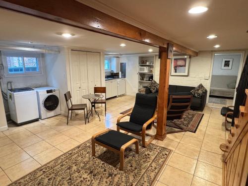 a living room with a table and chairs and a kitchen at First Floor One Bedroom Apartment with Full Kitchen & Bath in Washington, D.C.