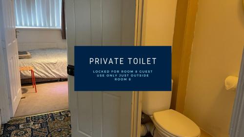 a bathroom with a toilet and a sign on the door at Entire 8 Ensuite Bedroom Coastal Holiday Home Townhouse, Free Parking, Fully Equipped Kitchen, Dining Room & Lounge, Perfect for Family Gatherings, Long Term Contractor, Relocation, etc Stays, 20 mins to Sunderland & Newcastle, See our Site for Assurance in South Shields
