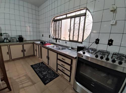 a kitchen with a sink and a window at Casa Nivaldo Ribeiro in Rio Verde