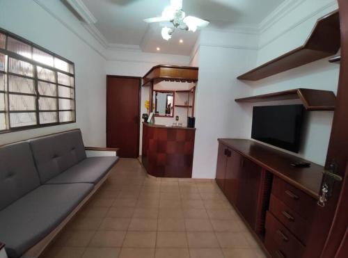 a living room with a couch and a flat screen tv at Casa Nivaldo Ribeiro in Rio Verde