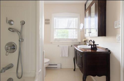 a bathroom with a sink and a toilet and a shower at Hummingbird Haven Bed & Breakfast Luxury Suite With Terrace & Seasonal Lake Views Located in Historic Old Town Niagara-On-The-Lake in Niagara-on-the-Lake