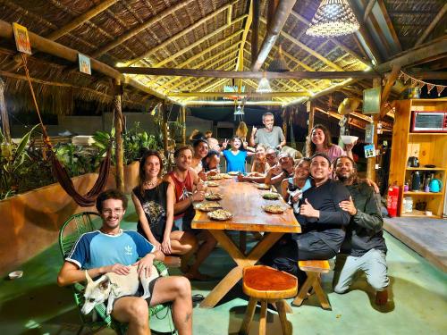 a group of people sitting around a table in a restaurant at Mapu in Pipa