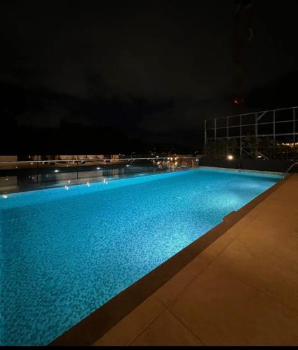 a swimming pool at night on a building at Luxury apartment 10 min to Airport Be Cariari Condo #402 in La Asunción