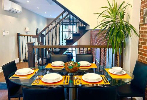 a dining room with a table and chairs and a staircase at Central Toronto in Toronto