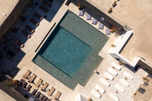 an overhead view of a swimming pool with chairs at Cavo Piso Livadi in Piso Livadi