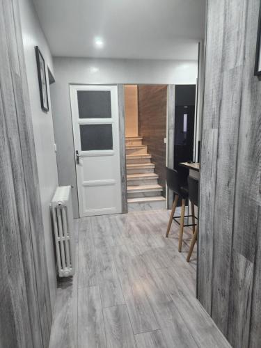 a hallway with a white door and stairs in a house at la Colombière in Longvic