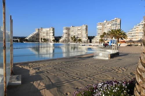 a view of a beach with buildings in the background at San Alfonso del Mar Ideal in Mirasol