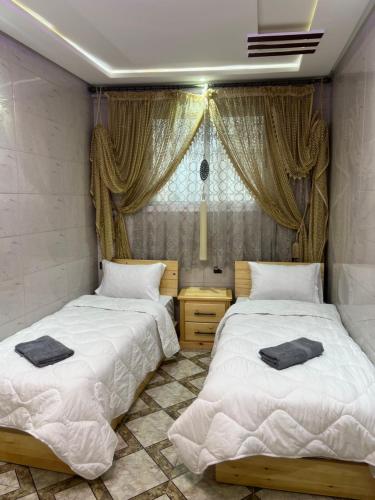 a bedroom with two beds and a window at Arinas Surf Hostel in Taghazout