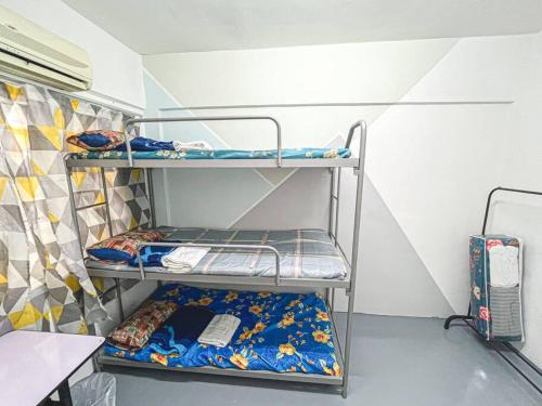 a room with three bunk beds in a room at Cheras, 1-10pax, FREE WIFI, 3BedRoom in Cheras