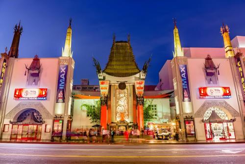 a building with a clock tower in front of a street at Modern Comfort in LA Free Parking&10 Min To Cedars in Los Angeles