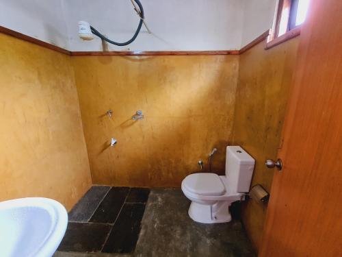 a bathroom with a toilet and a sink at sasru holiday home in Nuwara Eliya